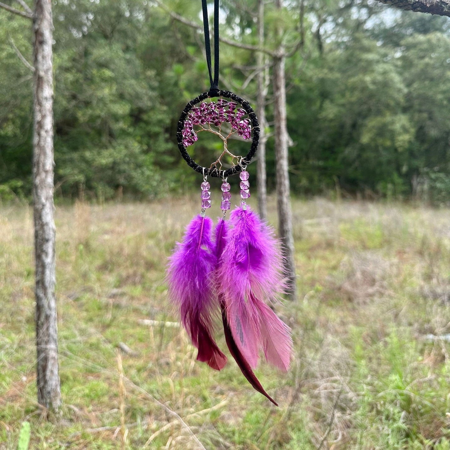 Handmade dark purple dreamcatcher with tree-of-life web and hanging purple feather strands