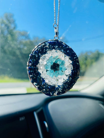Evil eye pendant with circular blue stone frame, light aqua center, hanging silver chain