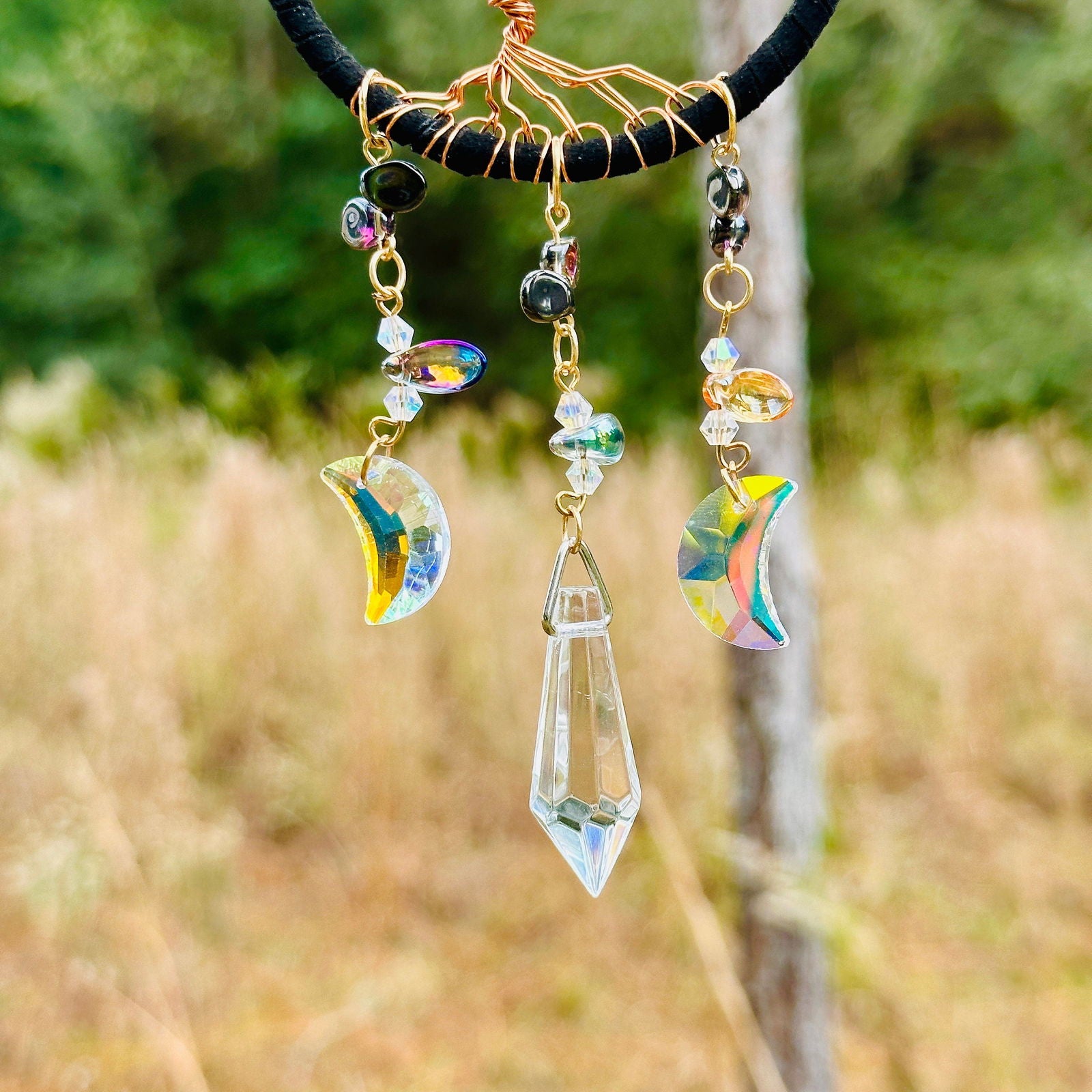 Hanging blue moon and prism charms on tree-of-life dreamcatcher suncatcher