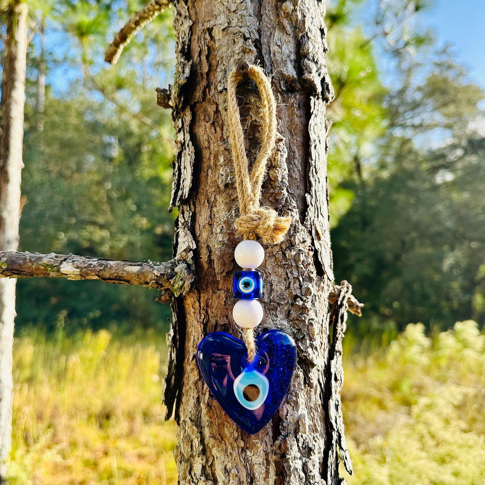 Blue heart evil eye wall hanging with white bead charms and rope loop