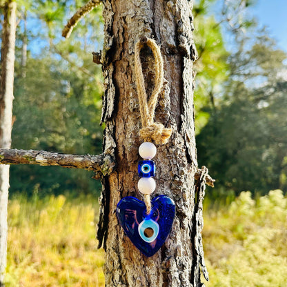 Blue heart evil eye wall hanging with white bead charms and rope loop