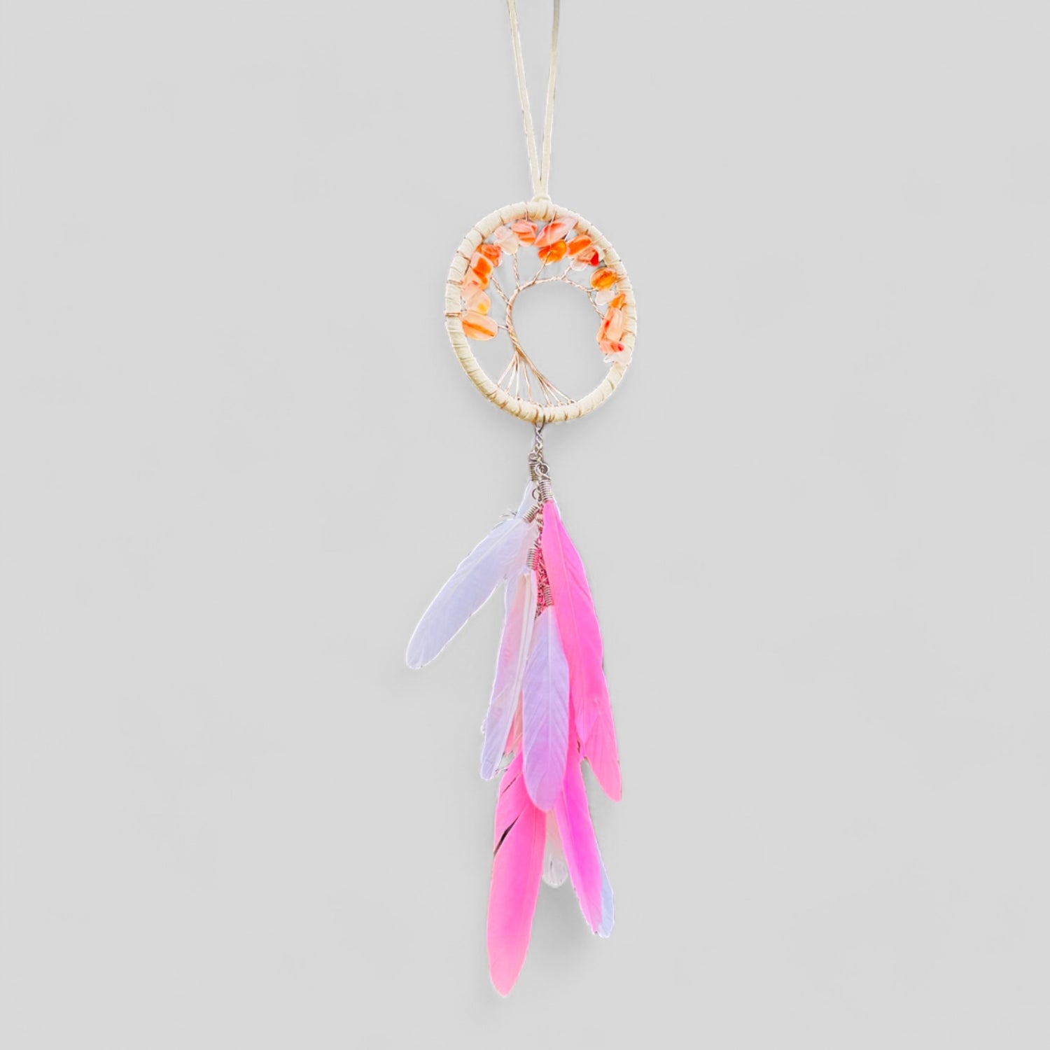 Pink dreamcatcher with ivory hoop, orange accents, and pink/purple feather tassel.