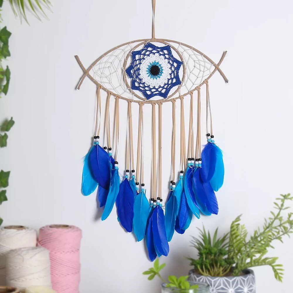 Evil-eye dream catcher wall hanging with tan frame and blue feather fringe