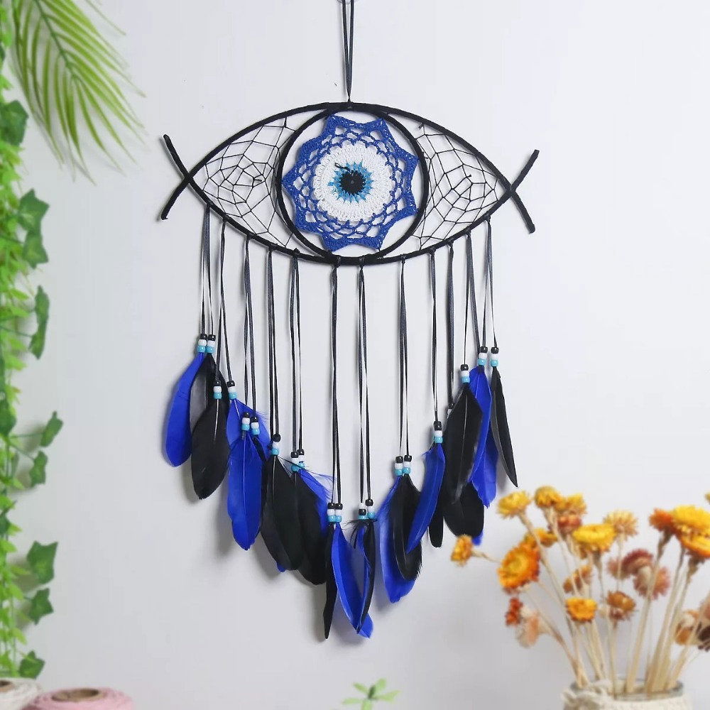 Evil-eye dream catcher wall hanging with black net, blue feathers, and dark fringe