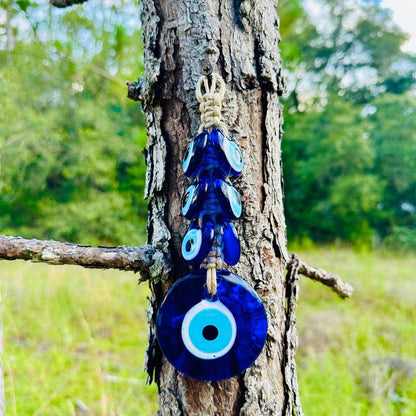Evil eye wall hanging with dark macrame and three blue glass beads on a knot loop