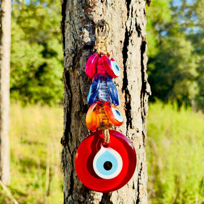 Colorful macrame evil-eye wall hanging with pink, blue, orange resin beads and rope tie