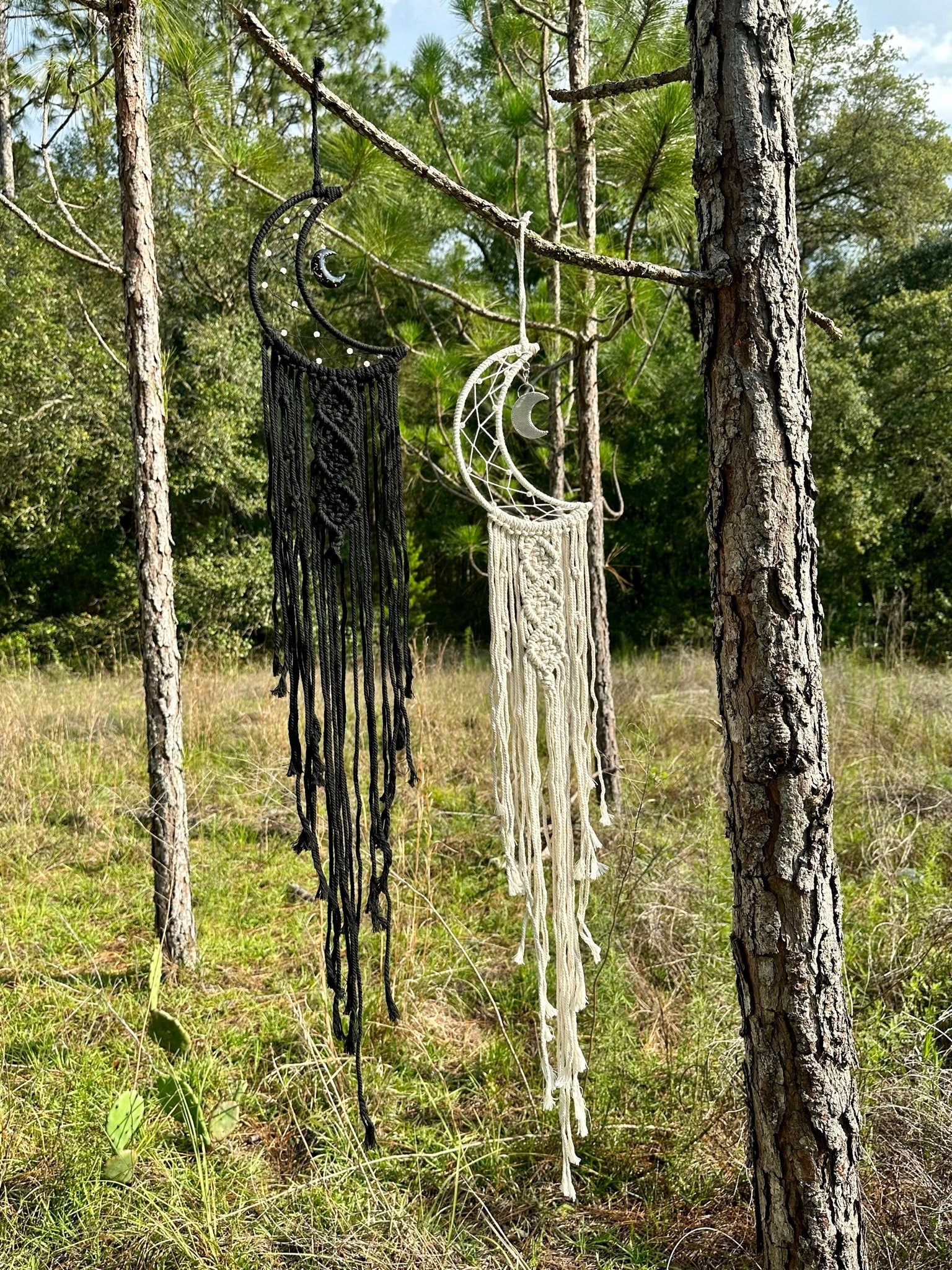 Macrame dream catcher wall hanging with crescent moon charms, black and cream fringe