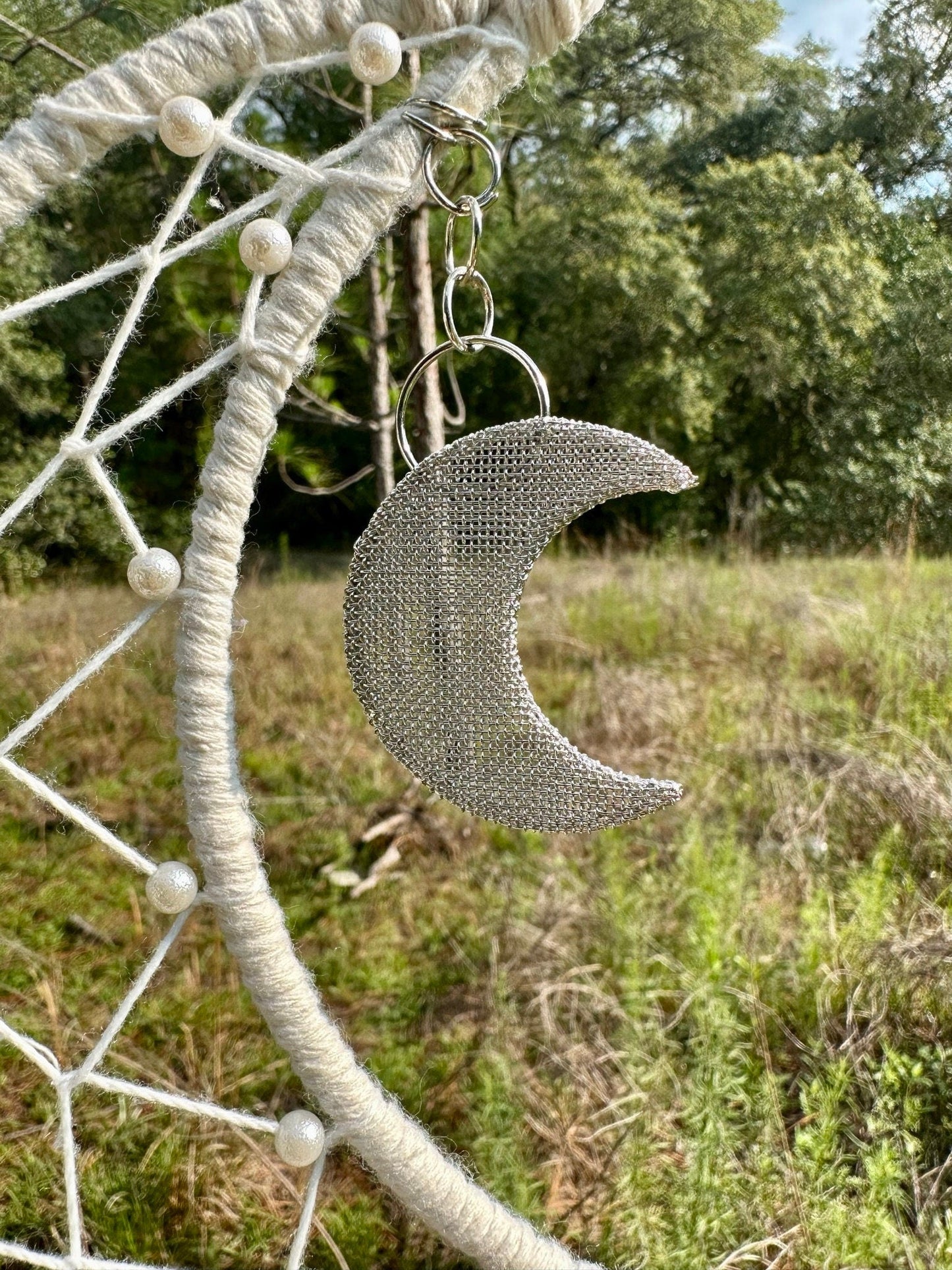 Cream macrame dream catcher with crescent moon charm hanging from woven ring