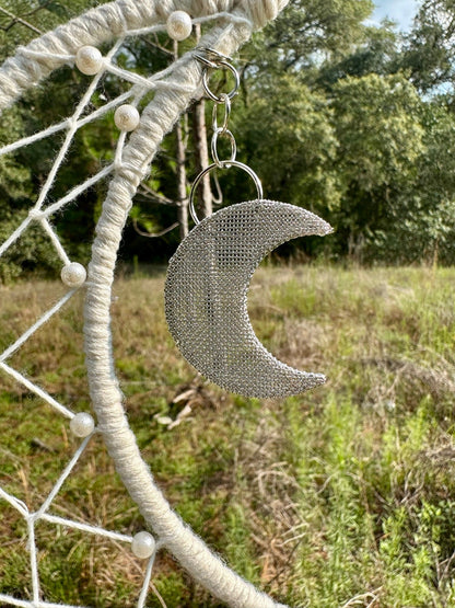 Cream macrame dream catcher with crescent moon charm hanging from woven ring