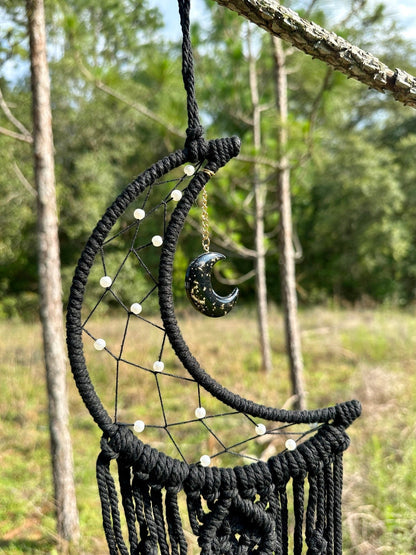 Black macrame dream catcher wall hanging with crescent moon charm and long fringe