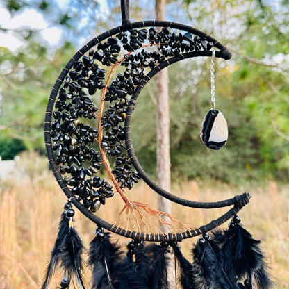 Crescent moon dream catcher wall hanging with black beads, feathers, and hanging stone charm