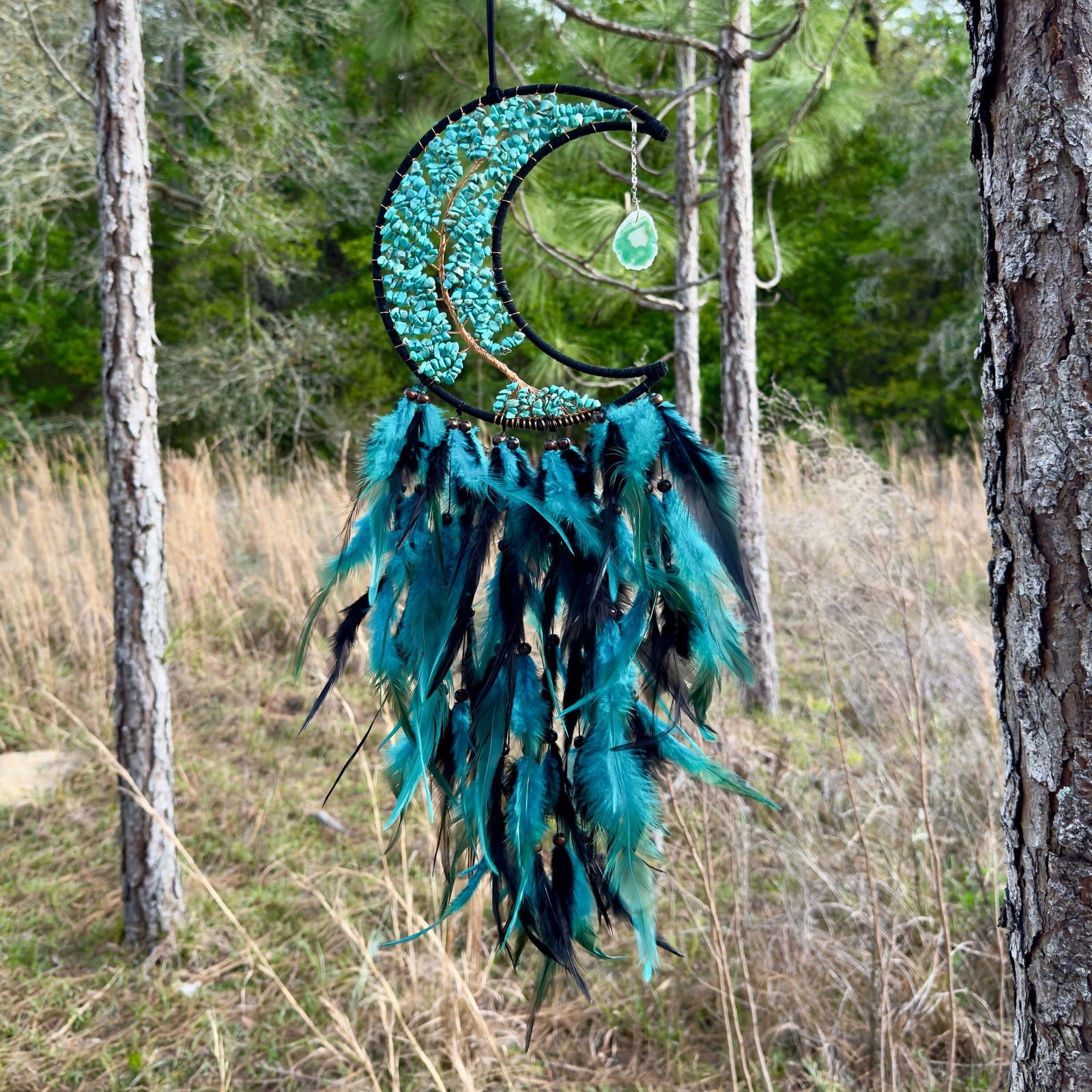 Crescent moon dream catcher wall hanging with turquoise stones and blue feathers
