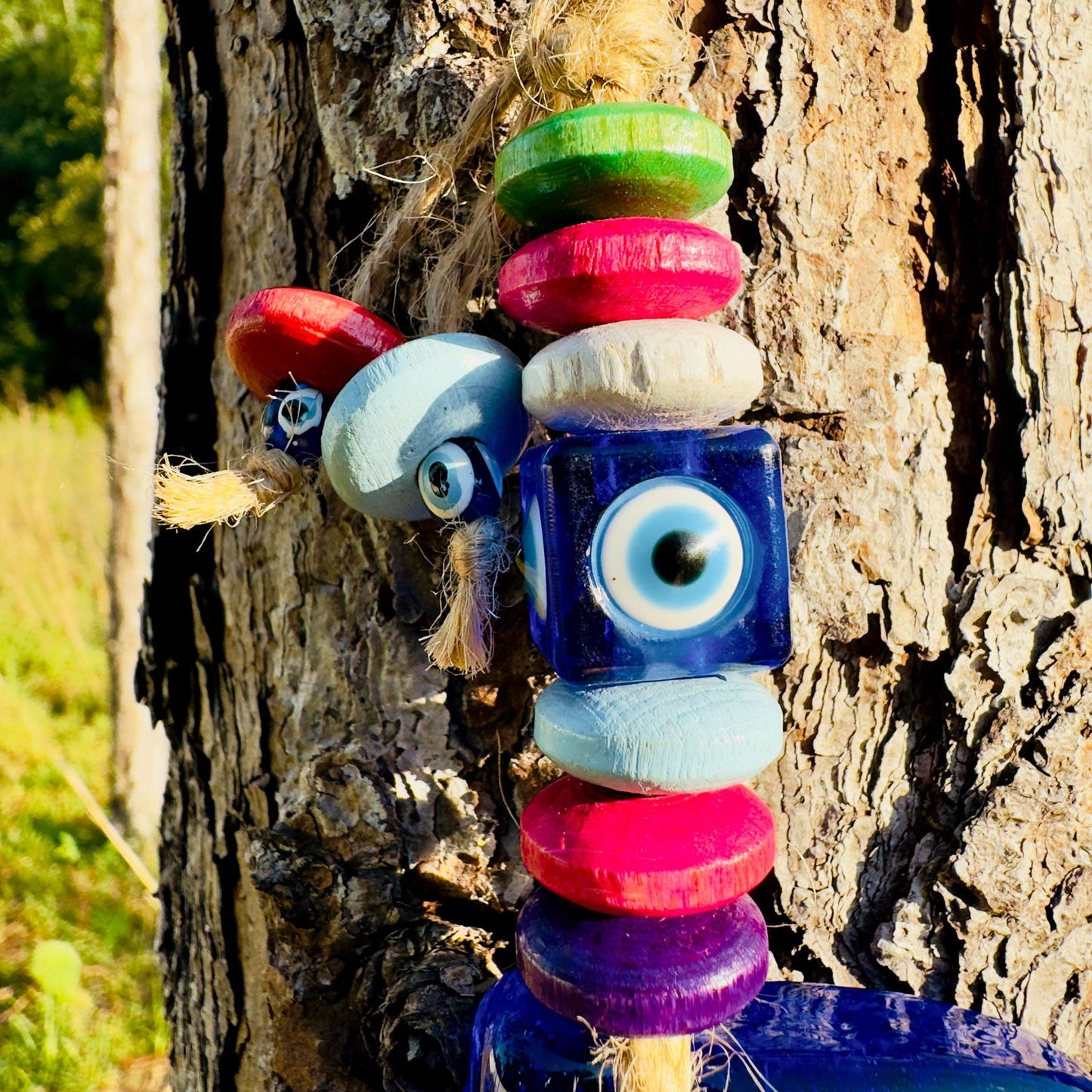 Blue dolphin wall hanging with square evil-eye charms and multicolor wood beads