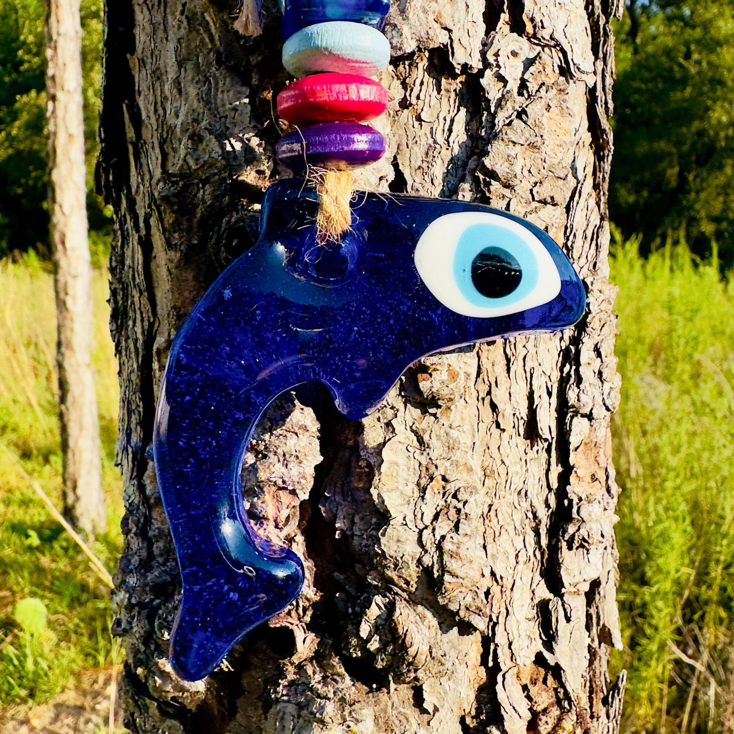 Blue dolphin evil eye charm with large white eye and colorful bead accents