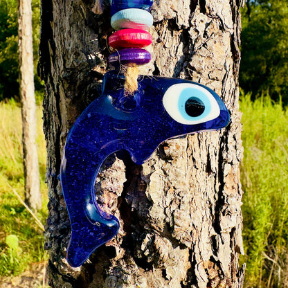 Blue dolphin evil eye charm with large white eye and colorful bead accents