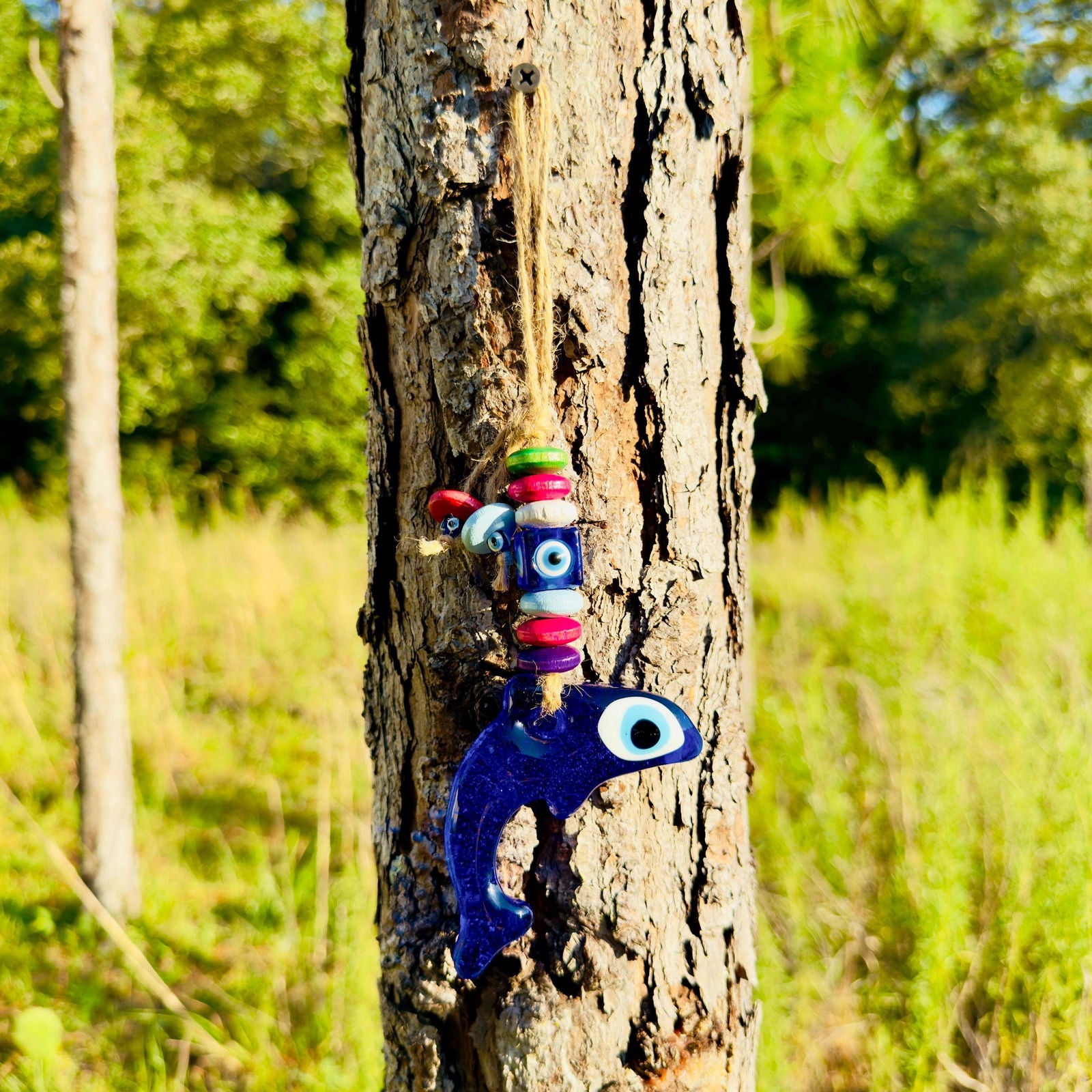 Blue dolphin evil eye wall hanging with colorful wood beads on string
