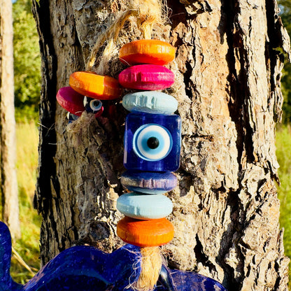 Mini elephant evil eye wall hanging with stacked orange, pink, and blue wooden beads