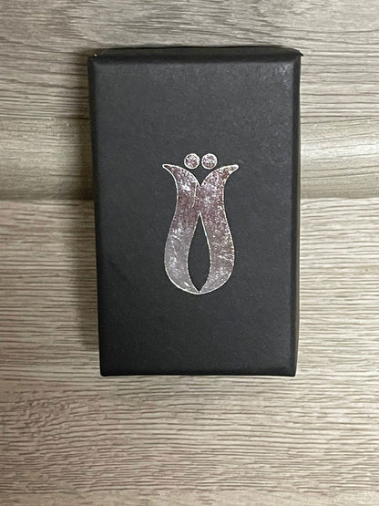 Gift box with silver evil eye cat-shaped pendant graphic