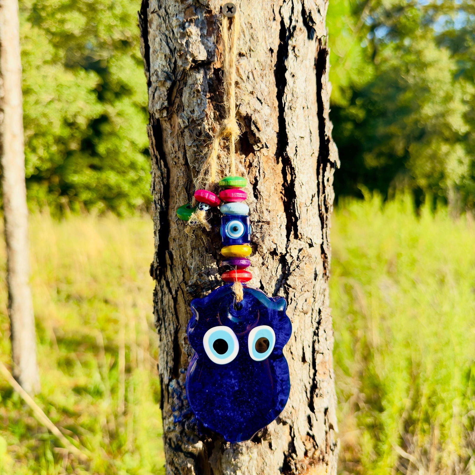 Mini blue owl wall hanging with multicolor wood beads and evil-eye eye details