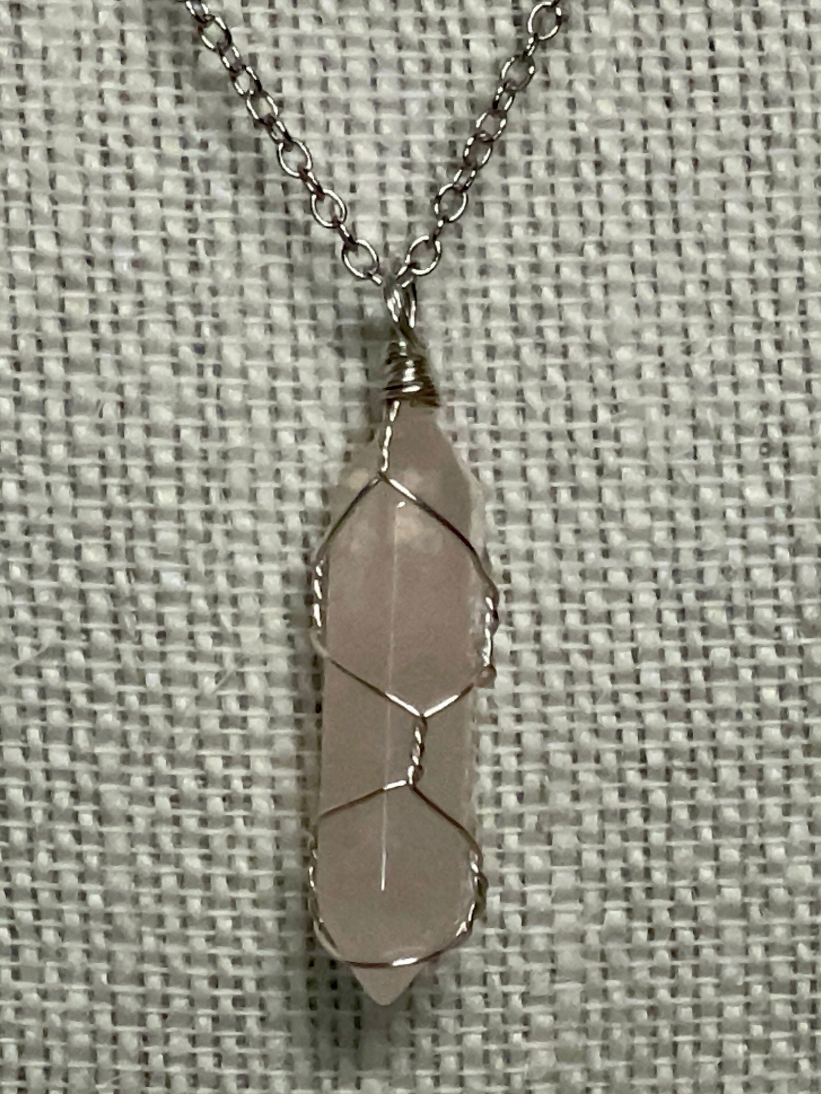 Silver wire-wrapped gemstone necklace with pale pink crystal pendant