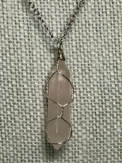 Silver wire-wrapped gemstone necklace with pale pink crystal pendant
