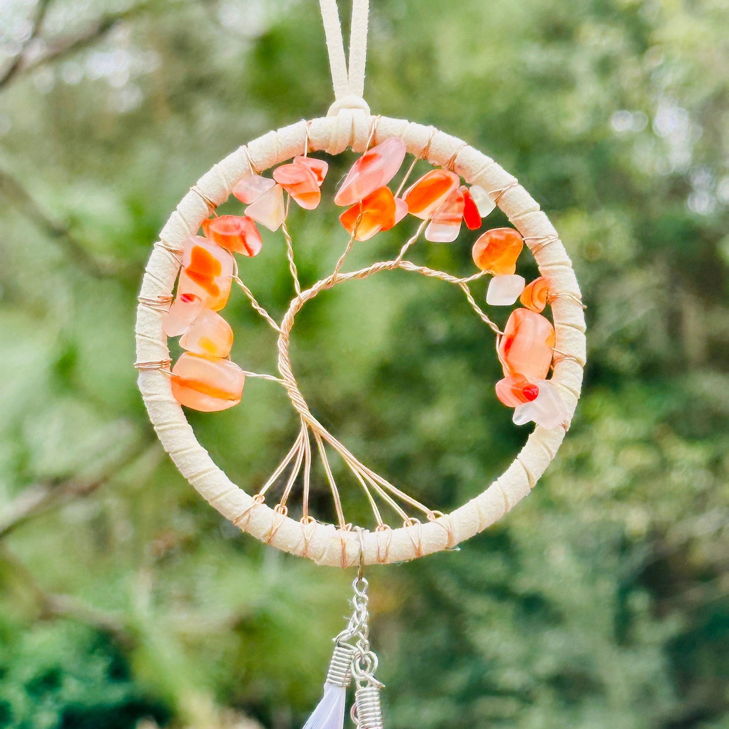 Orange and white dreamcatcher ring with orange petal-like loops and web