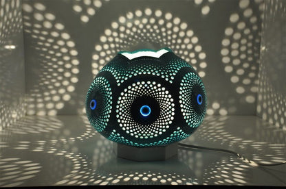 Turquoise mosaic table lamp with circular evil eye pattern and dotted details