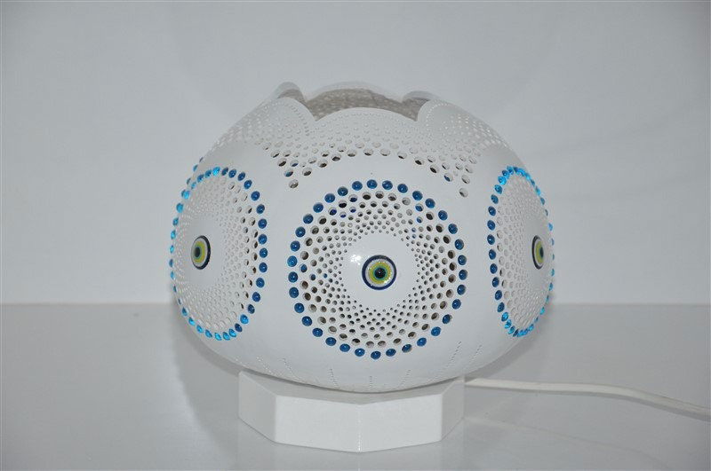 White evil eye mosaic table lamp with blue dot detailing, on square base stand