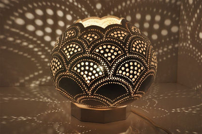 Moroccan mosaic table lamp with scalloped gourd shade, dark gold and black pierced pattern.