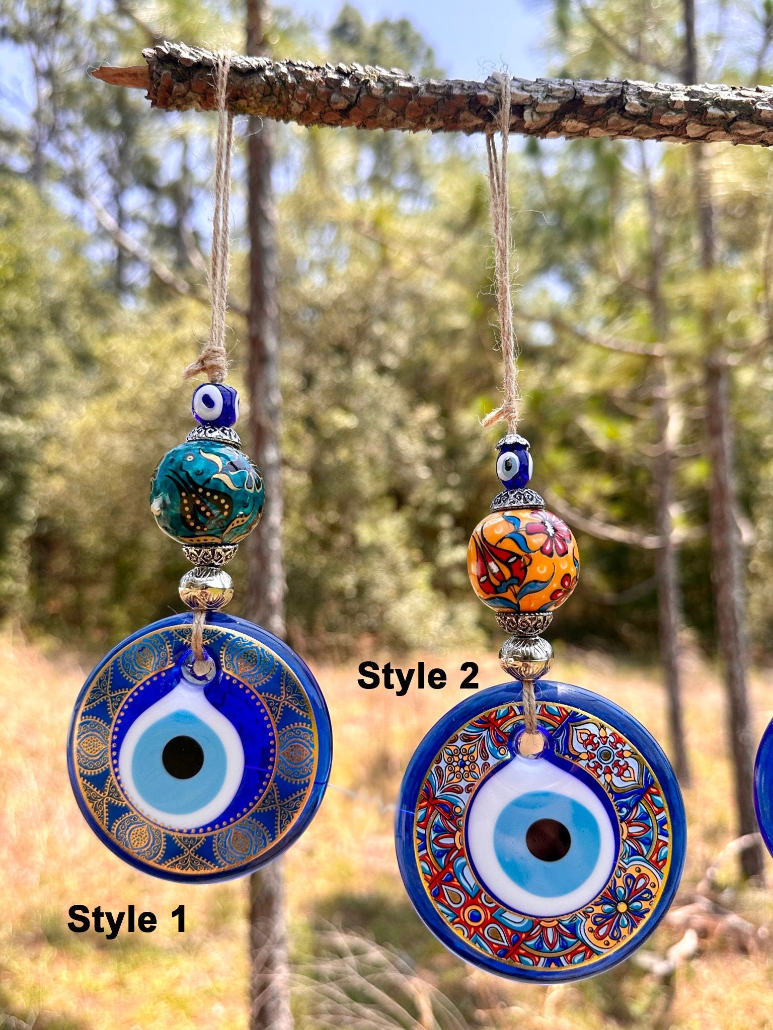 Ceramic evil eye wall hanging with two hanging round blue charms and bead accents