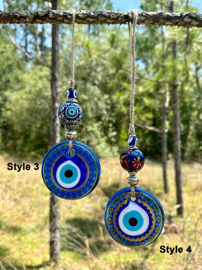 Ceramic evil eye wall hanging with two round blue evil-eye disks and small bead toppers