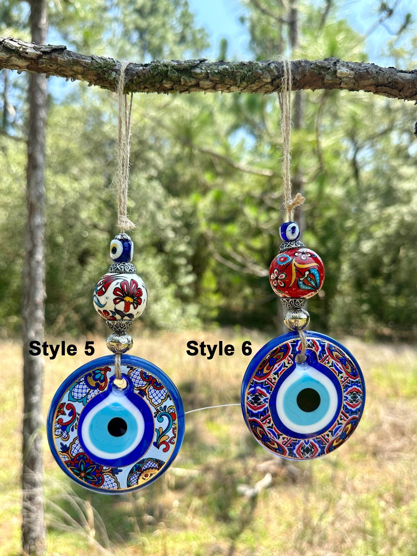 Ceramic evil eye wall hanging with two large blue evil-eye disks and red floral beads