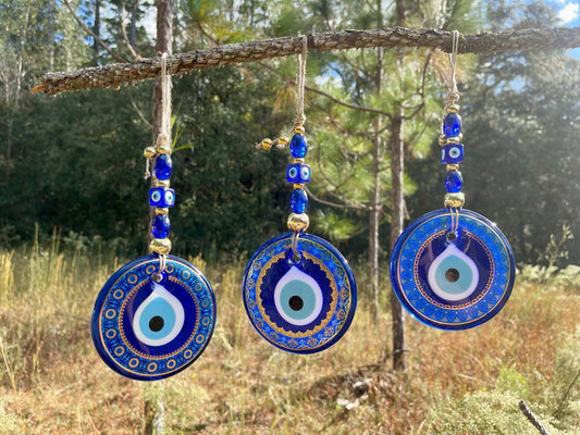 Set of three blue evil eye wall hangings with round pendants and bead tassels