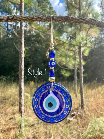 Blue evil eye wall hanging featuring a single round ornate pendant with bead links