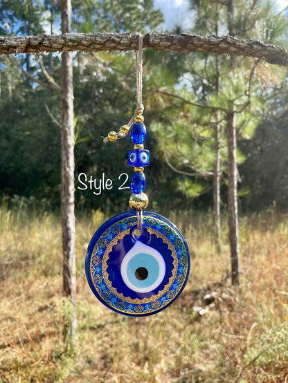 Blue evil eye wall hanging with round ornate pendant and dangling bead charms