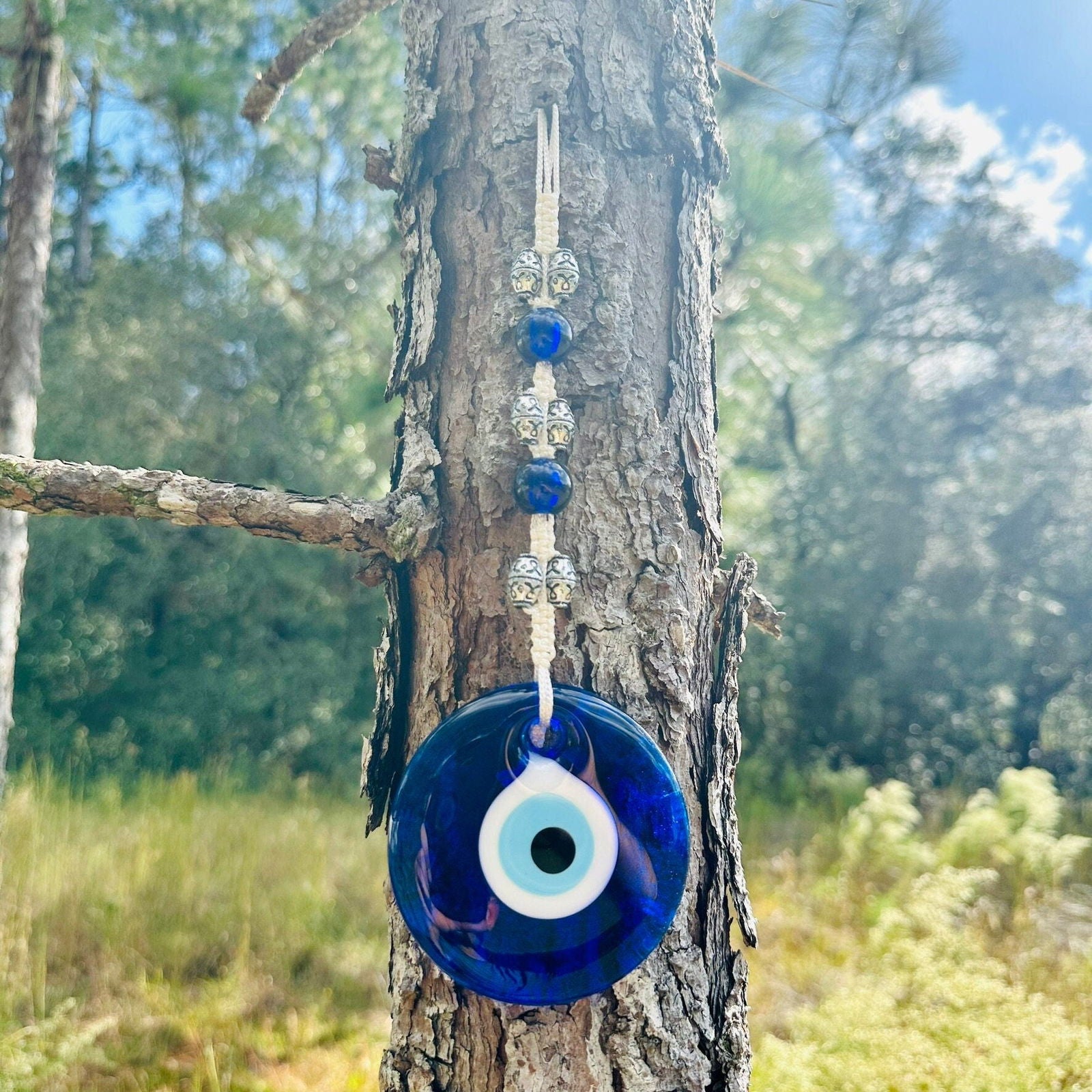 Blue evil eye glass charm wall hanging with hanging beads and white eye center