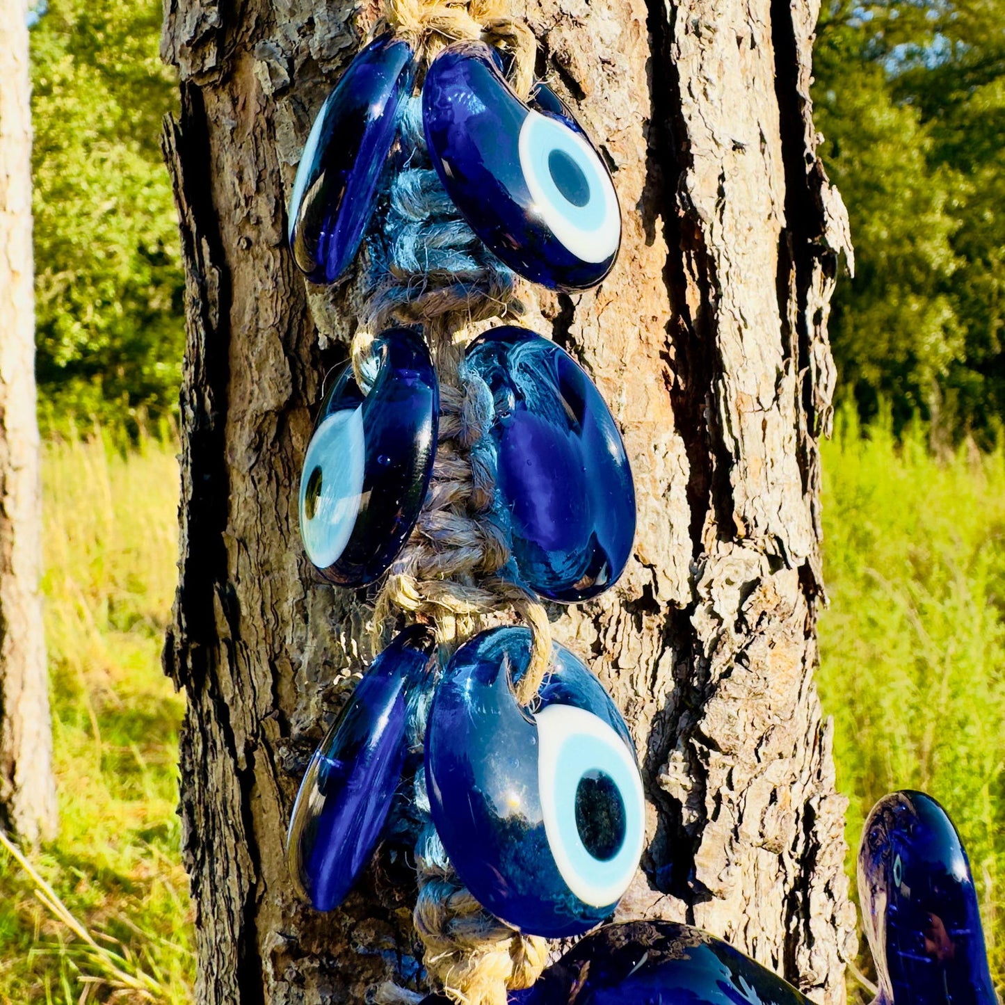Set of blue evil-eye charms on braided rope with small elephant amulet