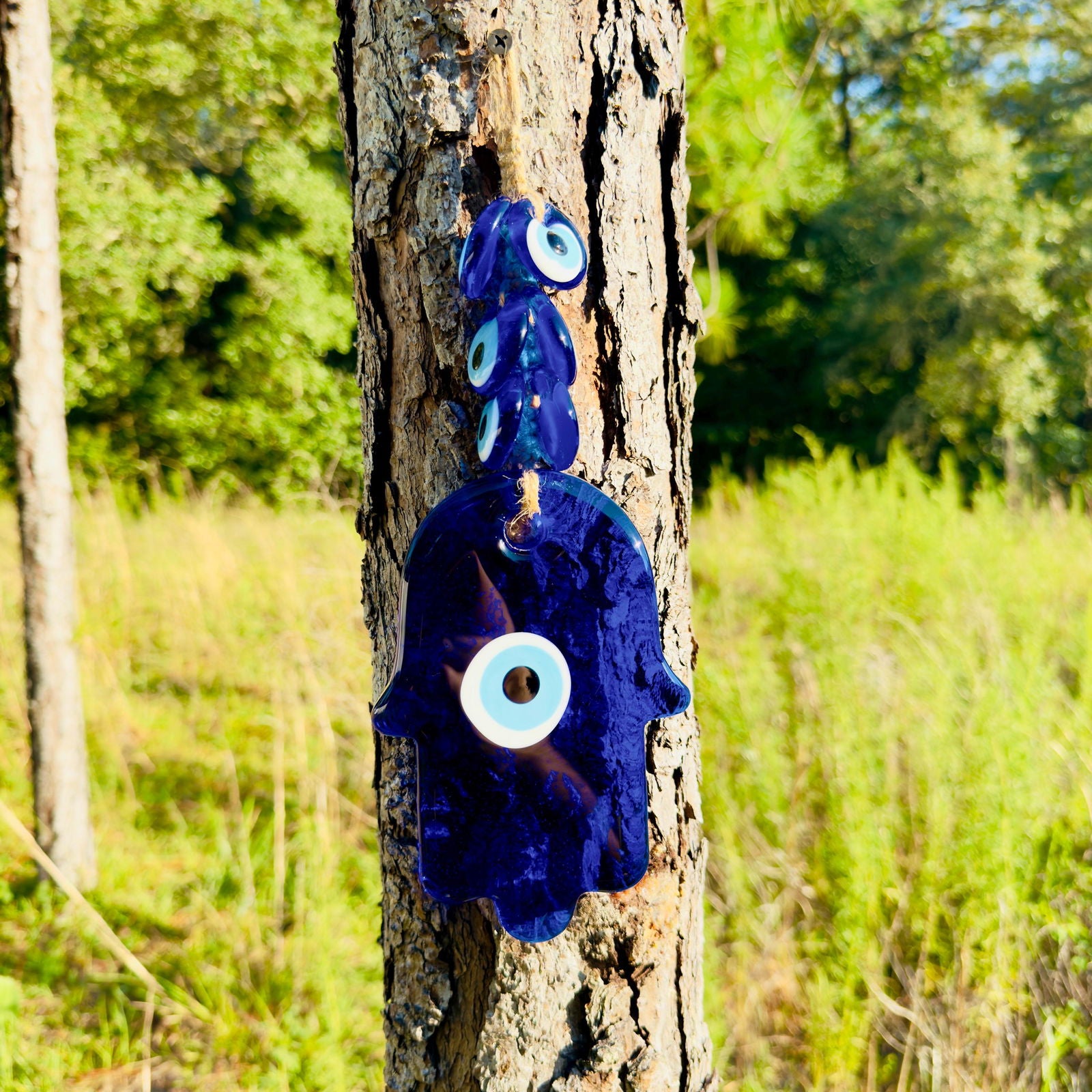 Blue hamsa wall hanging amulet with evil-eye discs on macrame rope