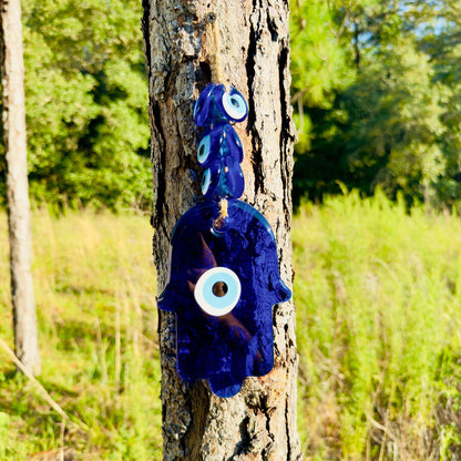 Blue hamsa wall hanging amulet with evil-eye discs on macrame rope