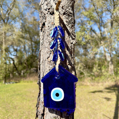 Blue evil eye house wall hanging with macrame cord and white eye charm.