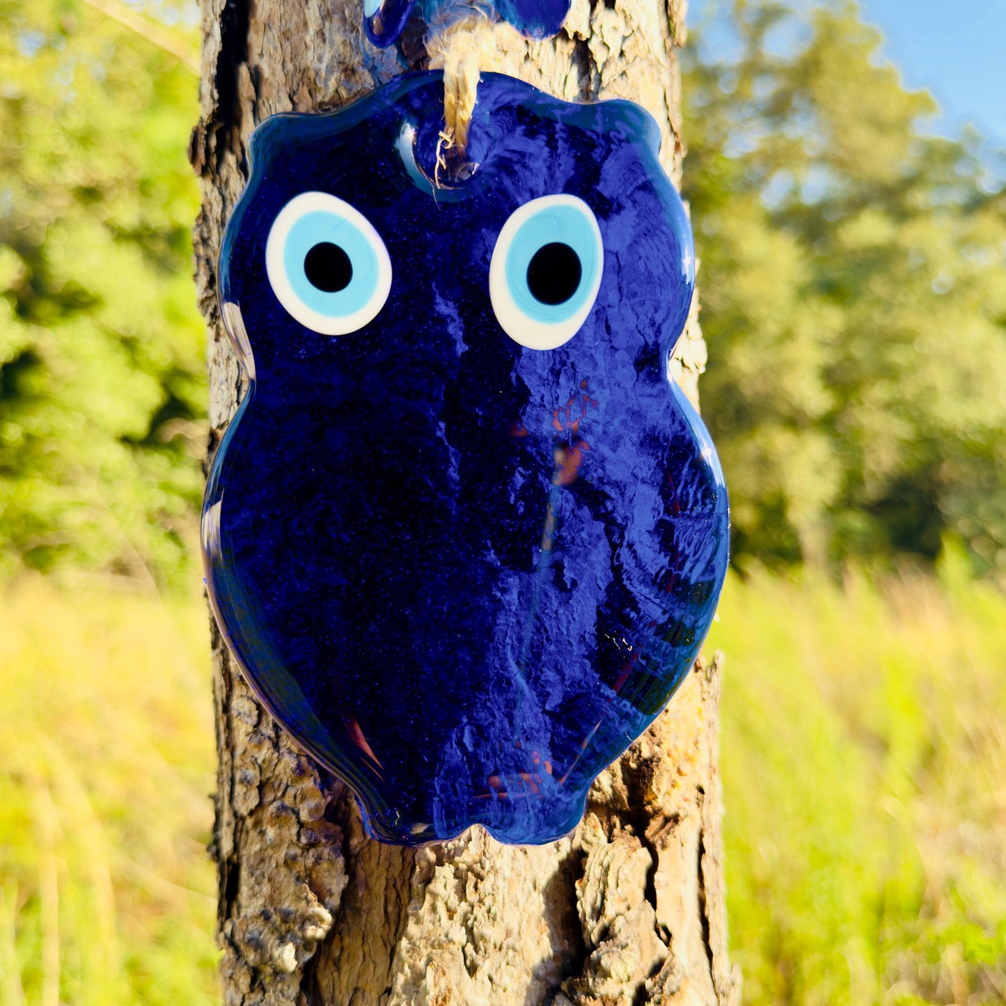 Blue evil-eye owl wall hanging macrame with large white-and-black eyes