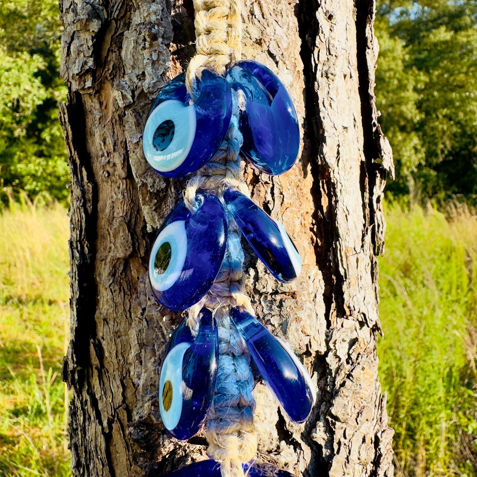 Stacked blue evil-eye owl wall hanging macrame pieces with dangling eyes on rope