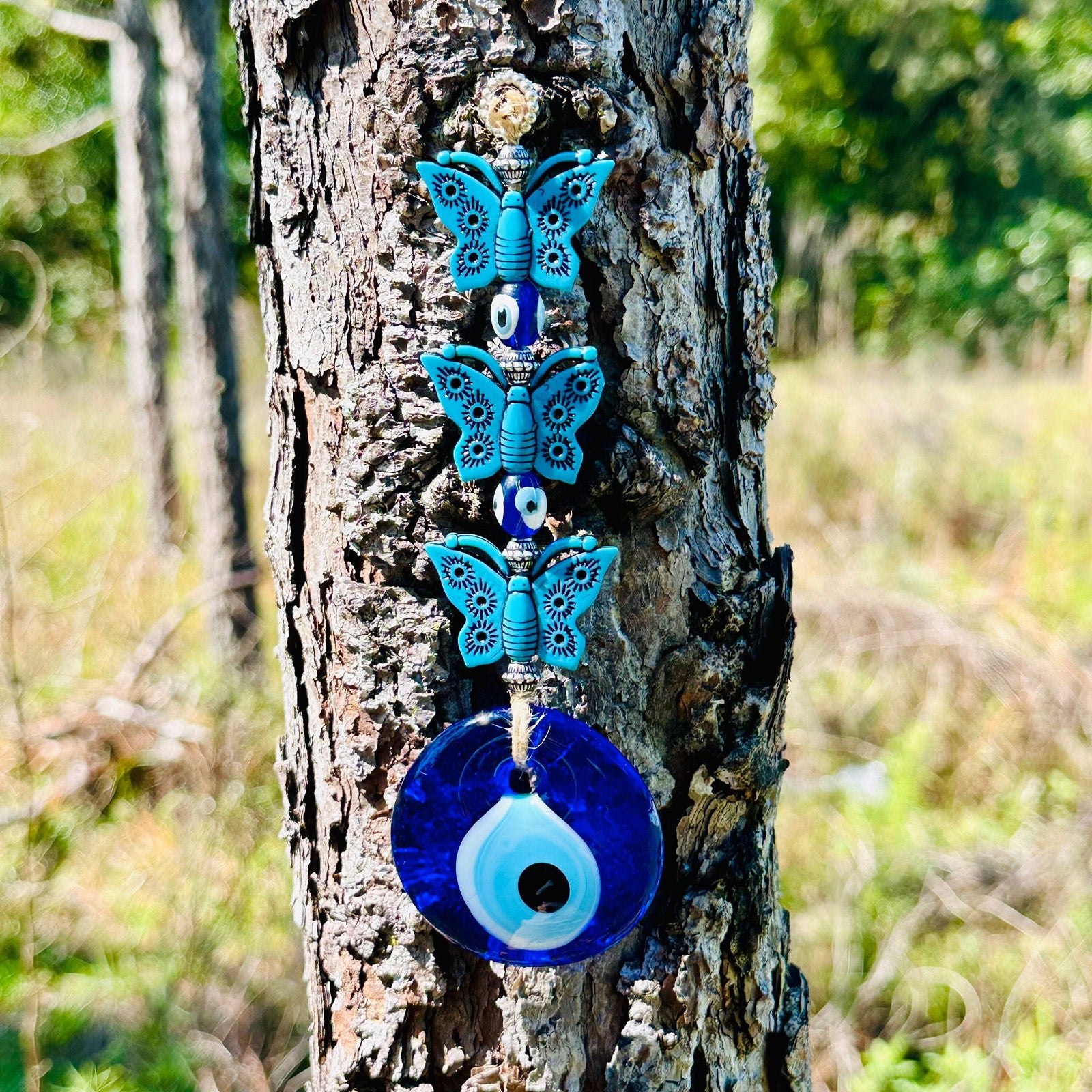 Turquoise butterfly charm wall hanging with evil eye bead and round blue pendant