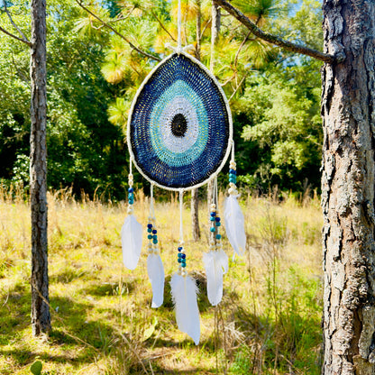 Teardrop evil-eye wall hanging, blue crochet beads with white feathers and dangling beads
